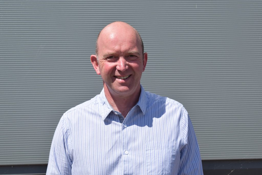 photo of Guy Crabb, a smiling man a white button up shirt