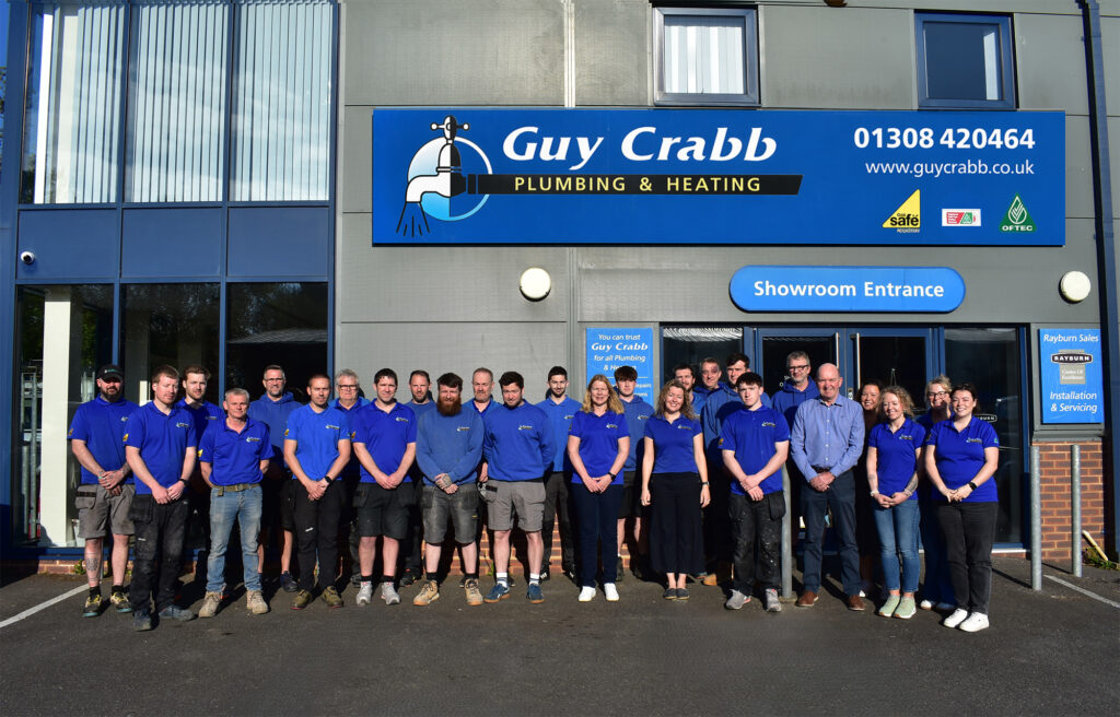 twenty people stood in work shirts outside place of work